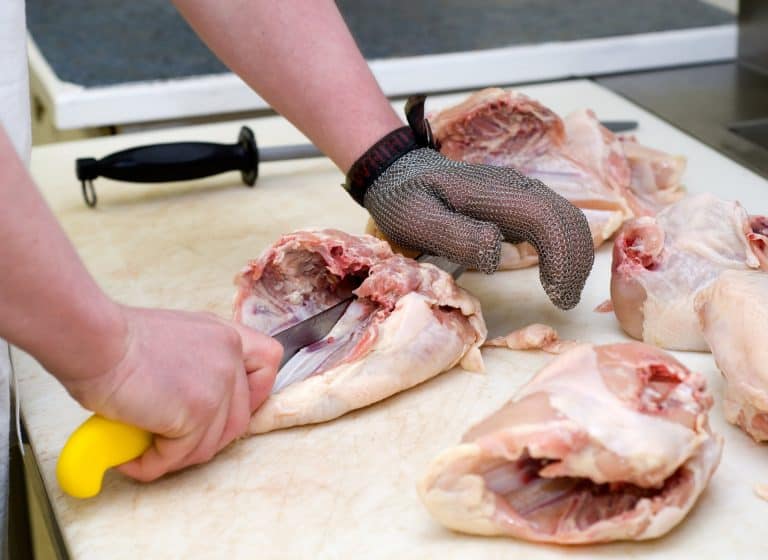 chicken breasts being cut