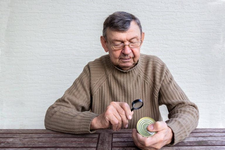 Elderly man reading food product label