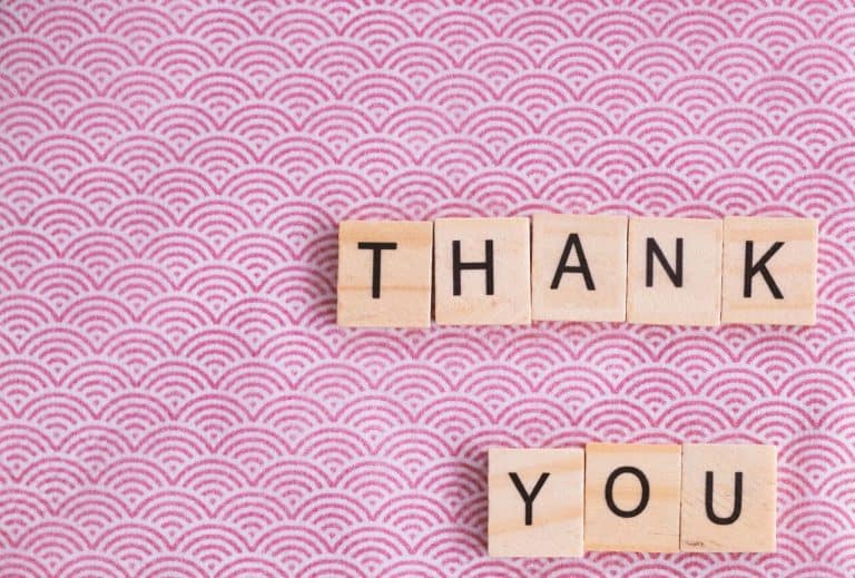 Scrabble letters on table saying thank you