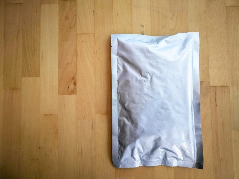 silver food packaging on a wooden background