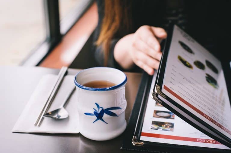 woman looking at menu at restaurant