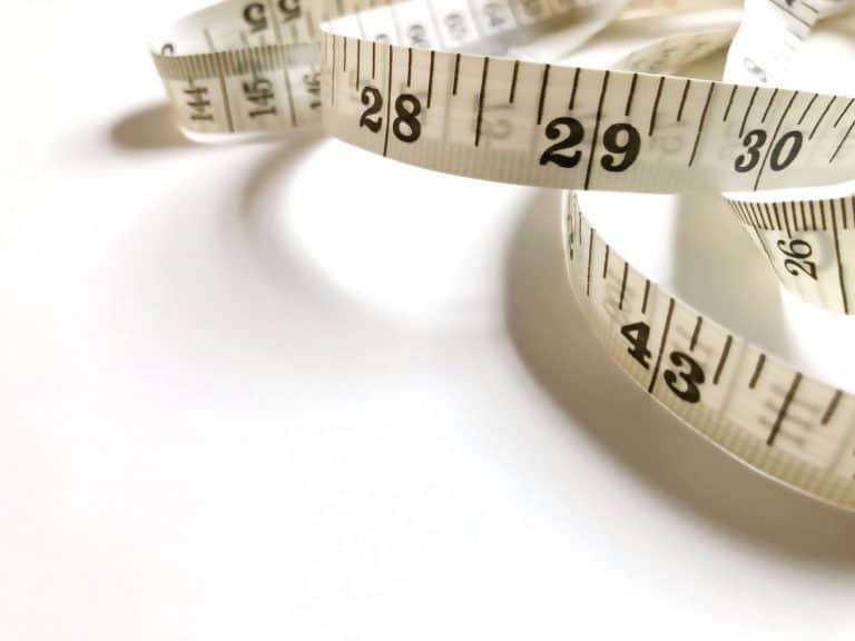 Measuring tape on white table