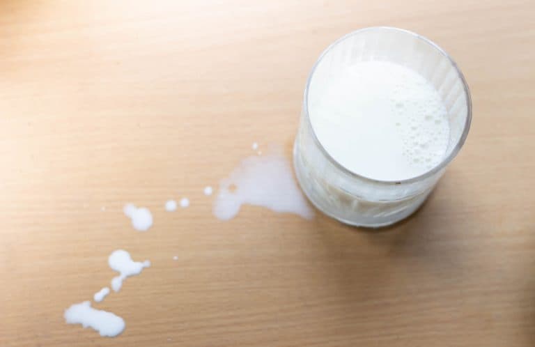 Milk spilt on wood table