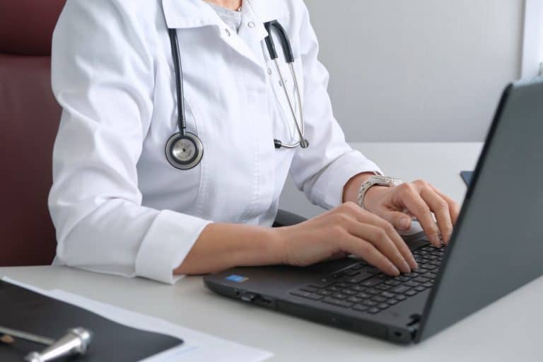 Health care professional working on computer