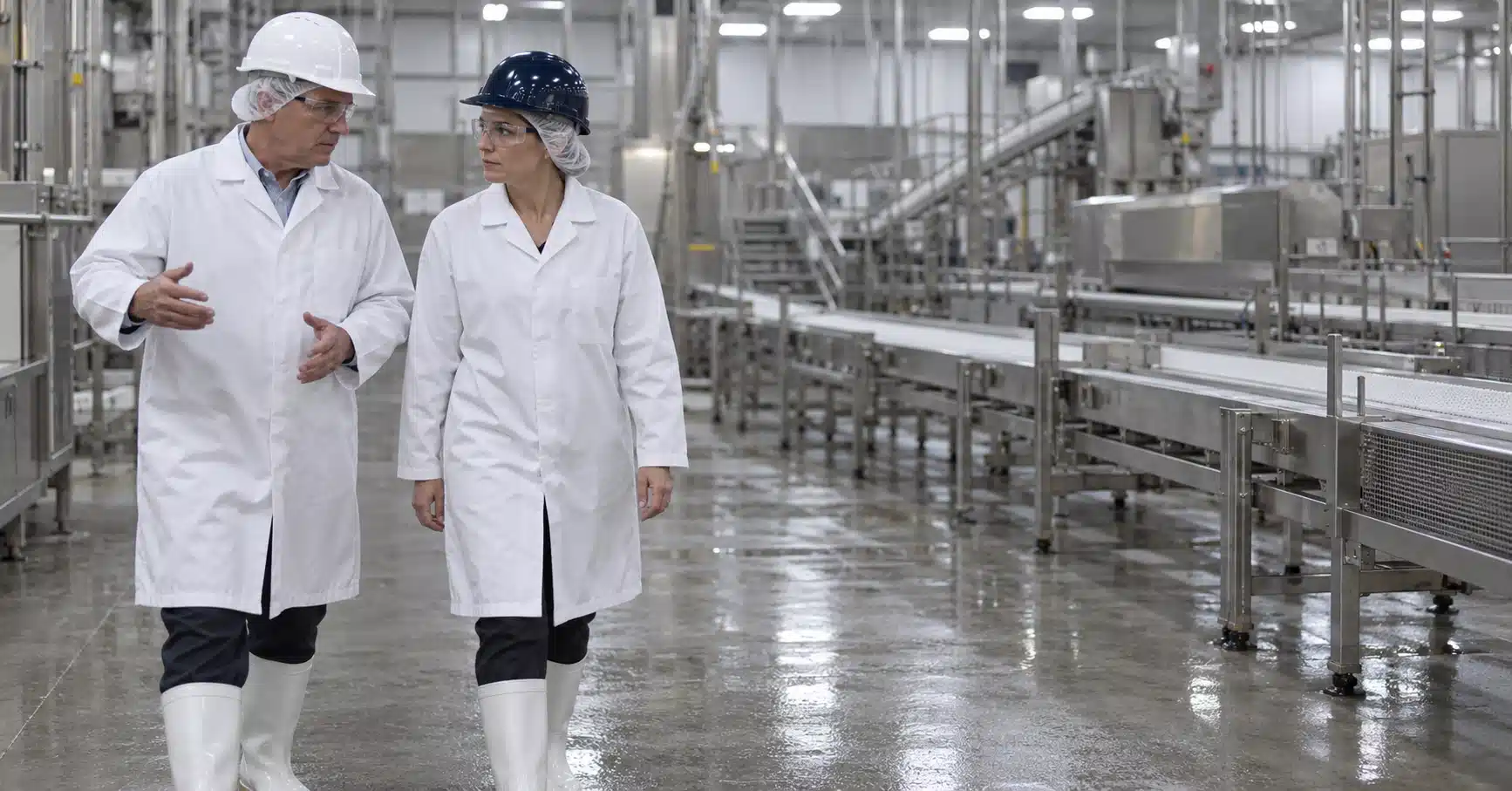 Meat and poultry plant manager walking an idle processing line with a government relations lawyer